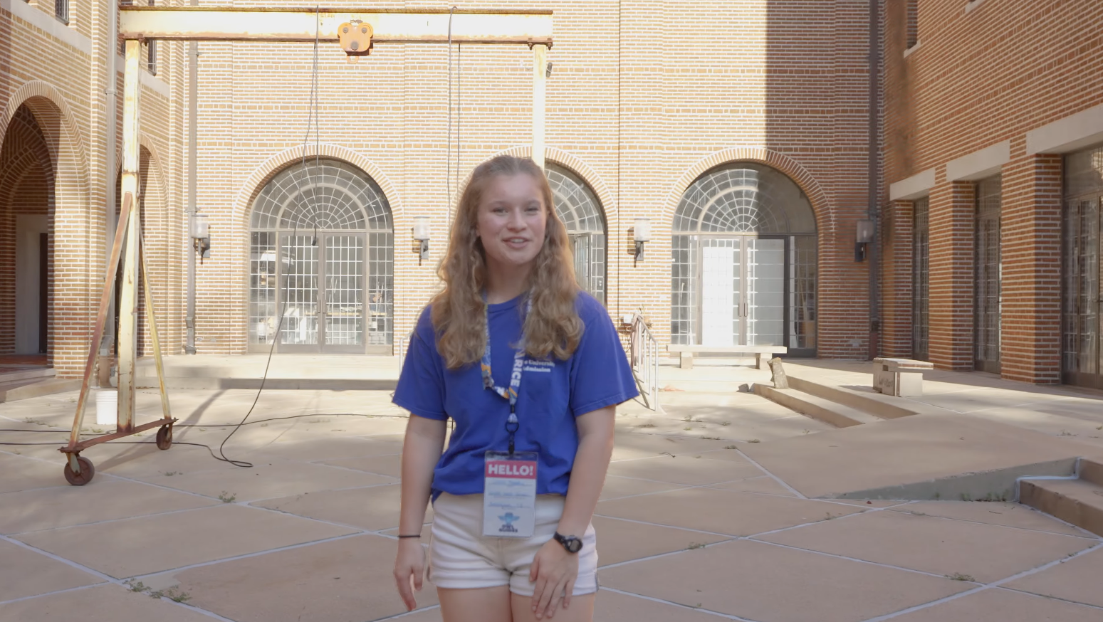 Tour guide standing in Sewall Hall courtyard during tour