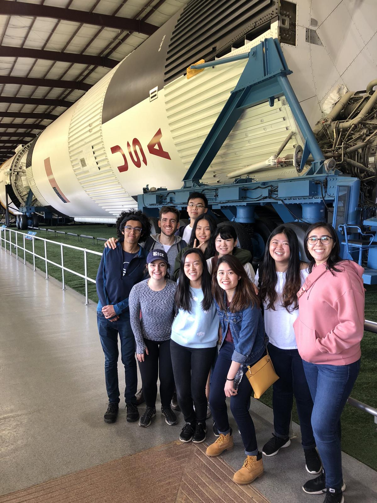 Vertical picture of students in front of a rocket at NASA.